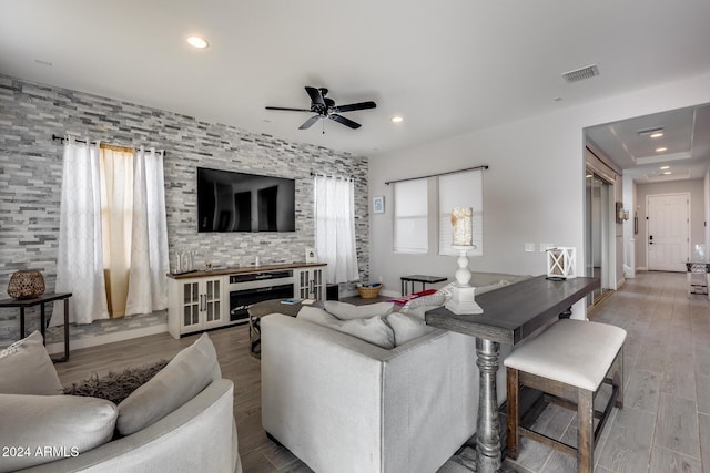 living room with a fireplace, hardwood / wood-style floors, and ceiling fan