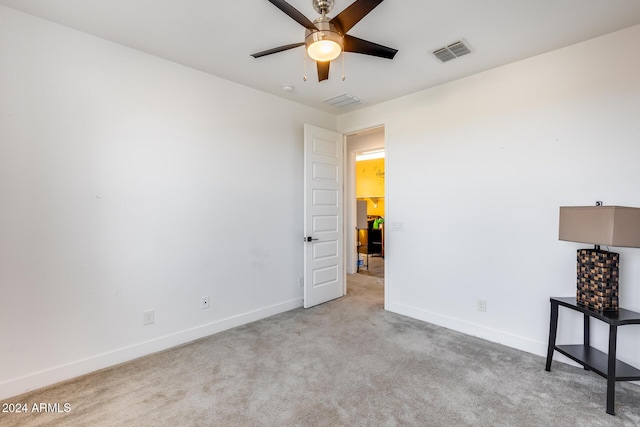 carpeted empty room with ceiling fan