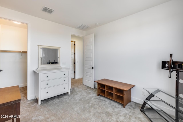 bedroom featuring light carpet and a closet