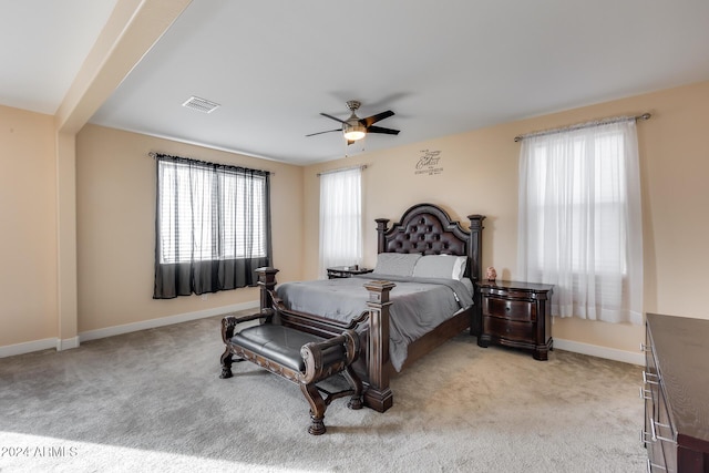 bedroom with ceiling fan and light carpet