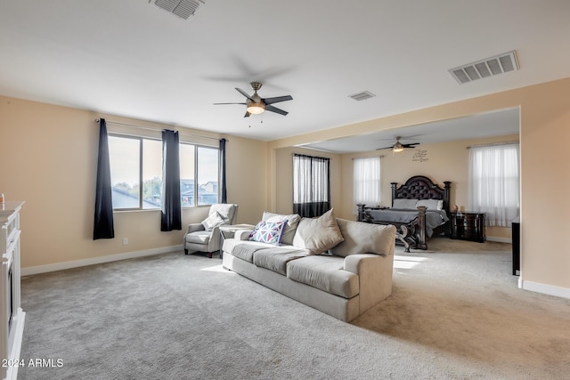 carpeted living room with plenty of natural light and ceiling fan