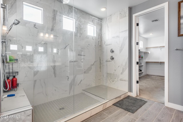 bathroom featuring a healthy amount of sunlight and an enclosed shower