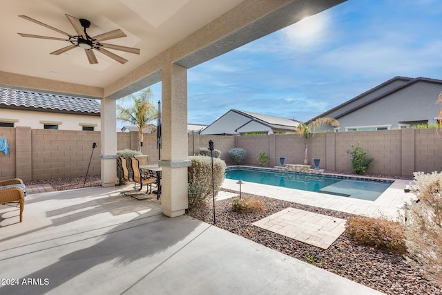 view of swimming pool with ceiling fan and a patio area