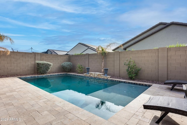 view of swimming pool featuring a patio area