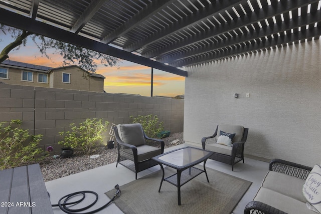 patio terrace at dusk featuring a pergola and an outdoor hangout area