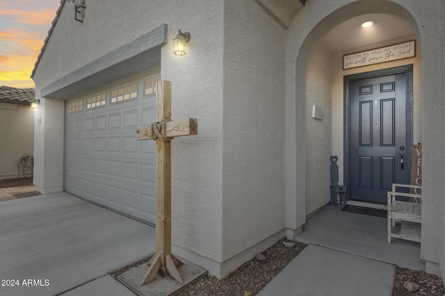 exterior entry at dusk with a garage