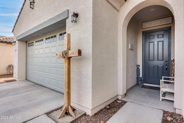 doorway to property with a garage