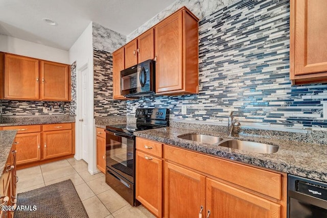 kitchen featuring light tile patterned flooring, sink, stone counters, decorative backsplash, and black appliances