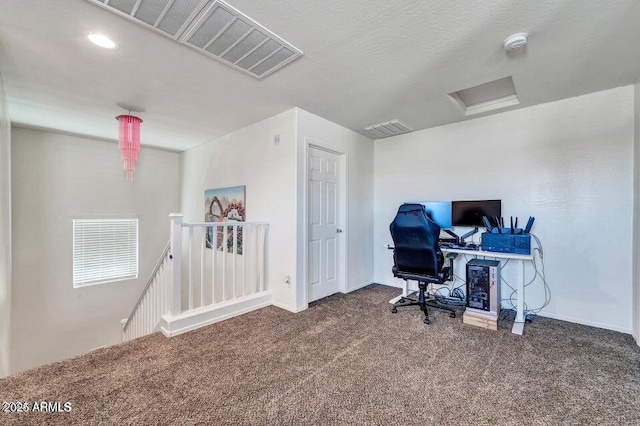 office with carpet floors and a textured ceiling