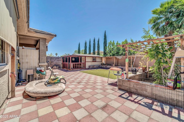 view of patio with a pergola and an outdoor structure