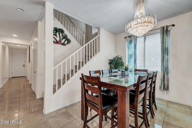 tiled dining area with a chandelier