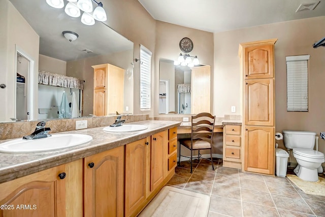 full bathroom featuring toilet, double vanity, visible vents, and a sink