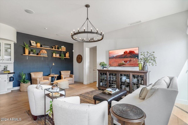 living room featuring an inviting chandelier and light hardwood / wood-style flooring