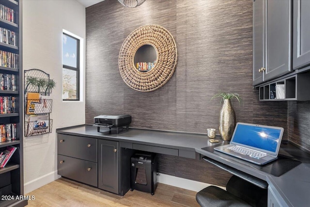 office area featuring built in desk and light hardwood / wood-style flooring