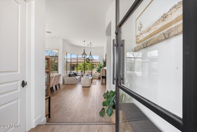 corridor with hardwood / wood-style floors