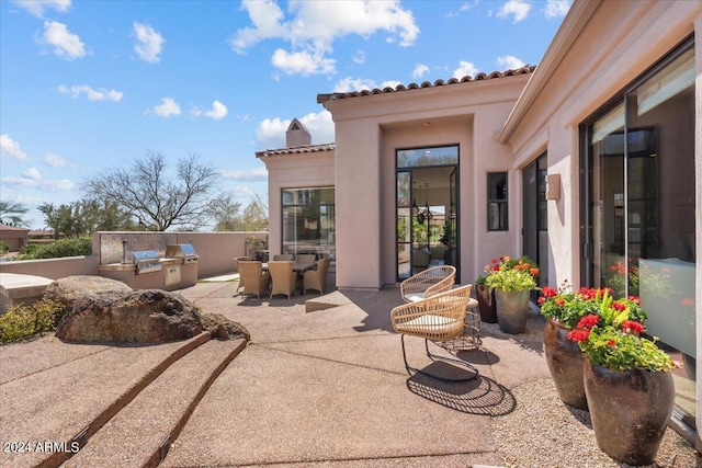 view of patio featuring exterior kitchen