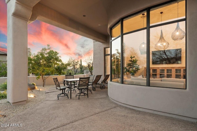 view of patio terrace at dusk