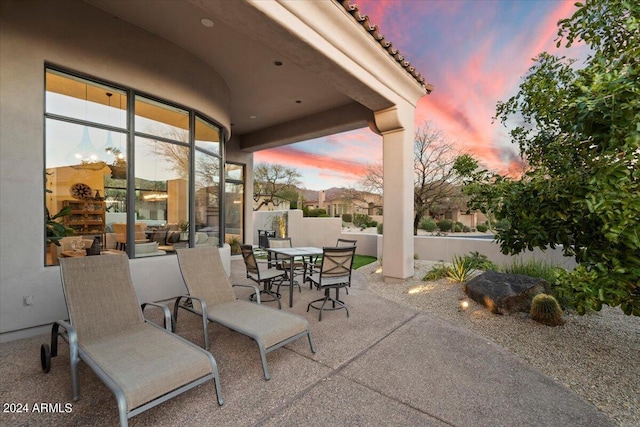 view of patio terrace at dusk