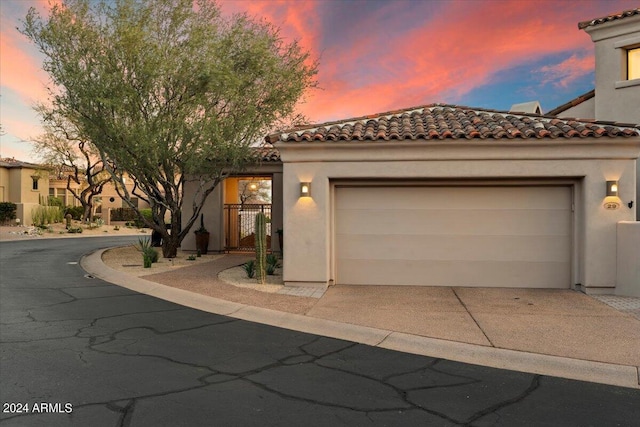 mediterranean / spanish-style home with a garage