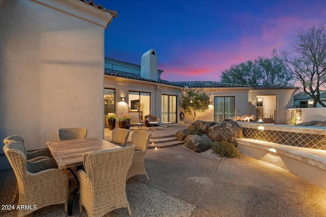 view of patio terrace at dusk