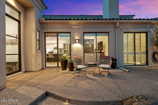 view of patio terrace at dusk