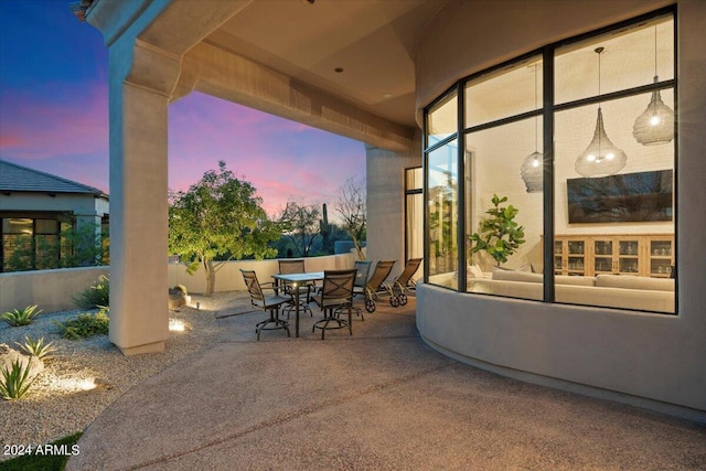 view of patio terrace at dusk