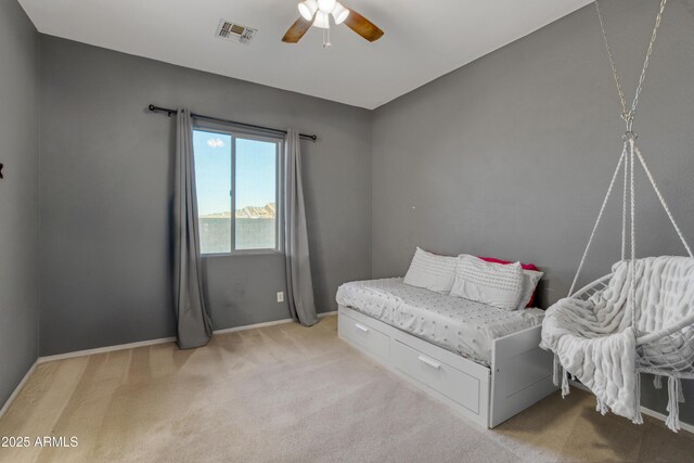 carpeted bedroom featuring visible vents, a ceiling fan, and baseboards
