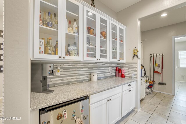 bar with decorative backsplash, fridge, baseboards, light tile patterned flooring, and recessed lighting