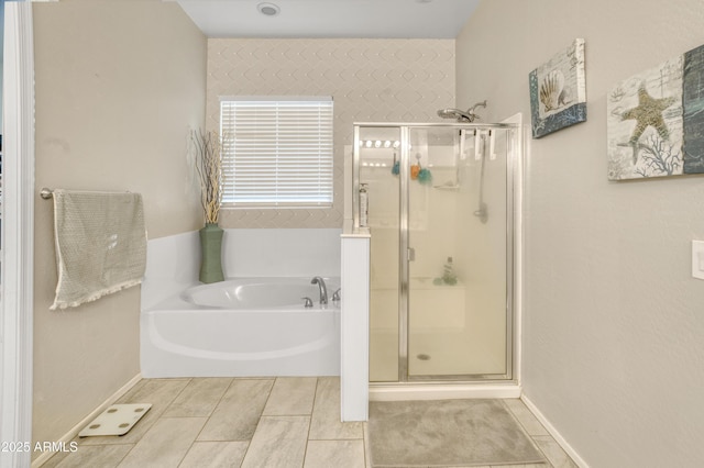 bathroom featuring a bath and a stall shower