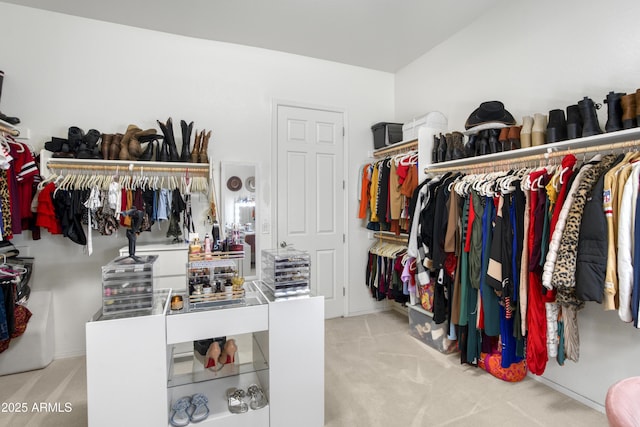 walk in closet with carpet flooring