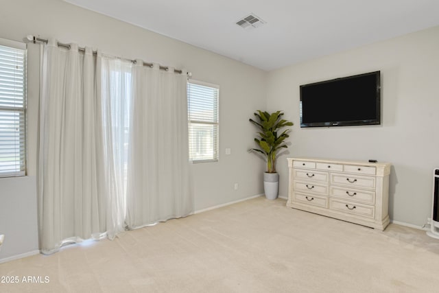 bedroom with visible vents, light colored carpet, and baseboards