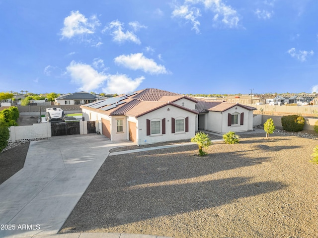 view of front of home featuring a garage, fence, driveway, and a tiled roof