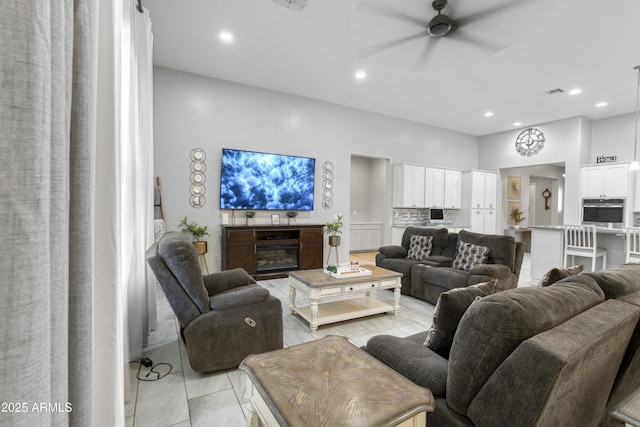 living room featuring visible vents, recessed lighting, light tile patterned floors, and a ceiling fan