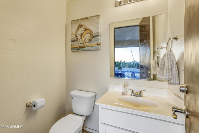 bathroom with toilet and vanity