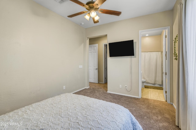 bedroom featuring ceiling fan, ensuite bath, visible vents, carpet, and baseboards