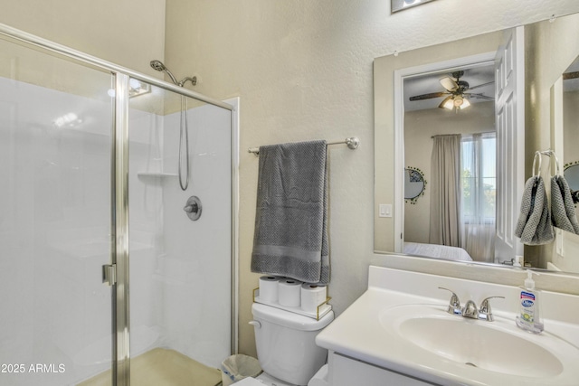 ensuite bathroom with a shower stall, vanity, ensuite bath, toilet, and a ceiling fan