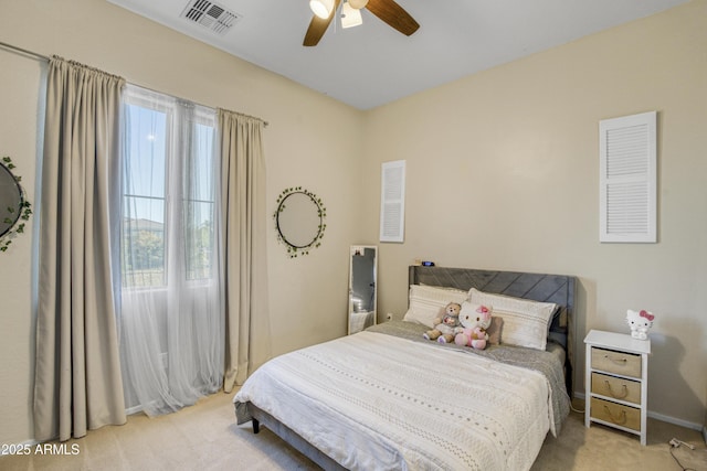 bedroom with carpet, visible vents, ceiling fan, and multiple windows