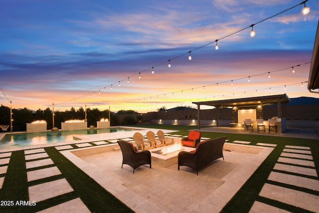 view of patio / terrace with a fire pit, an outdoor pool, and outdoor dry bar