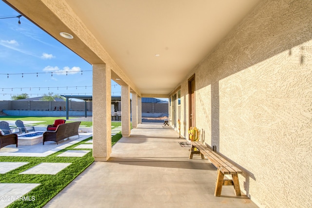 view of patio / terrace featuring fence and an outdoor fire pit