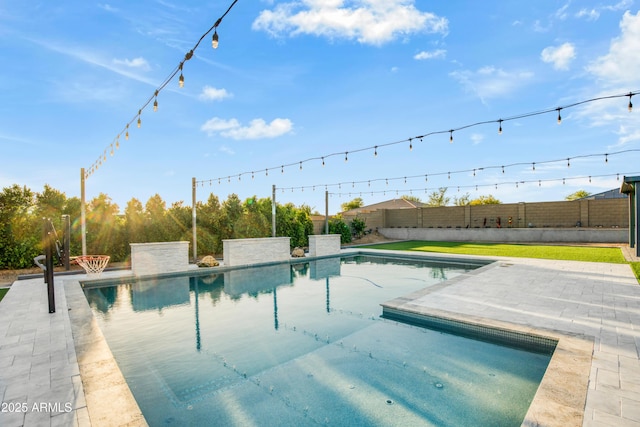view of swimming pool with a fenced in pool, a fenced backyard, and a patio area