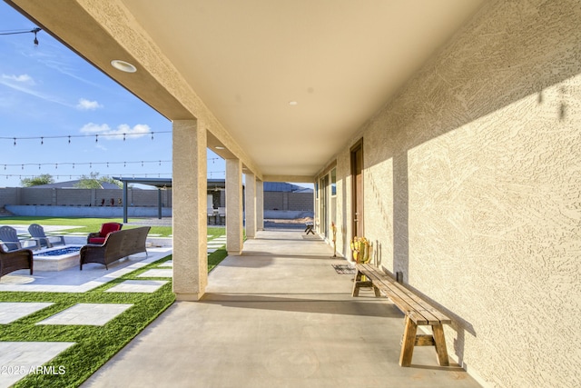 view of patio / terrace featuring fence and an outdoor fire pit