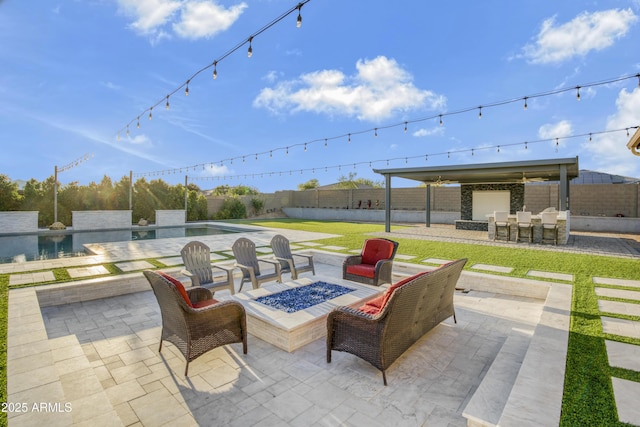 view of patio / terrace with a fire pit, a fenced in pool, a fenced backyard, and outdoor dry bar