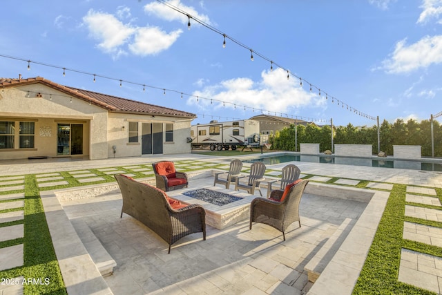 view of patio / terrace featuring an outdoor pool and an outdoor fire pit