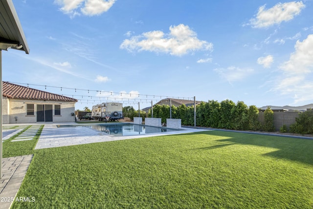 view of yard featuring fence, a patio area, and a fenced in pool