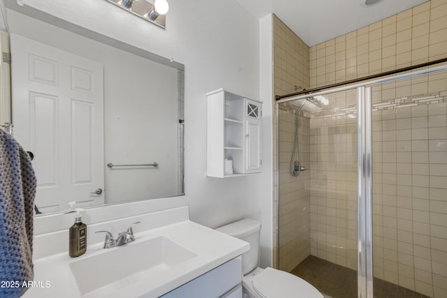 full bathroom with a stall shower, toilet, and vanity