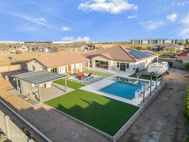 view of swimming pool with a residential view, a fenced in pool, a patio area, a yard, and a fenced backyard