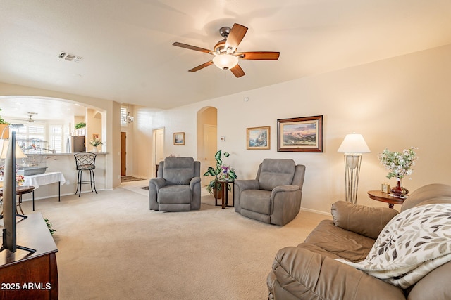 living room with light carpet and ceiling fan