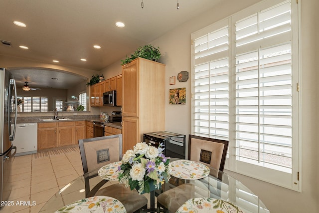 dining room featuring light tile patterned flooring, ceiling fan, and sink