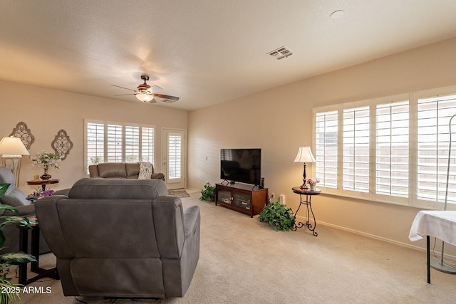 carpeted living room featuring ceiling fan