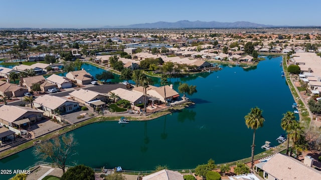 drone / aerial view featuring a water and mountain view